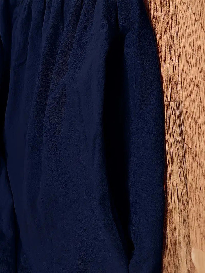 Women's flowing midi dress, elegant and practical, with convenient pockets.