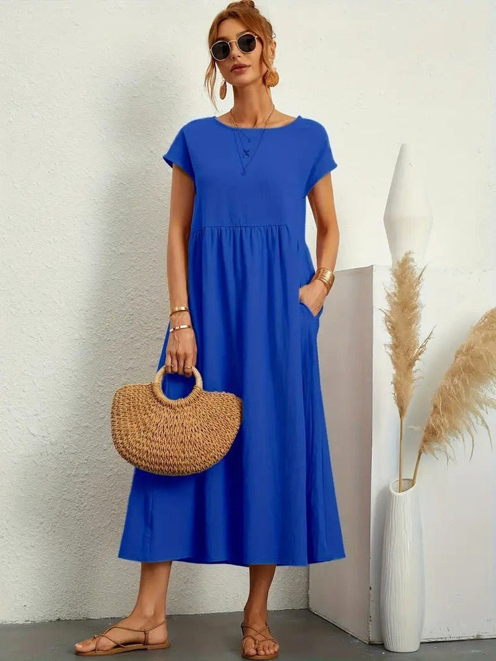 Elegant women's flowing midi dress with practical pockets, ideal for versatile styling.