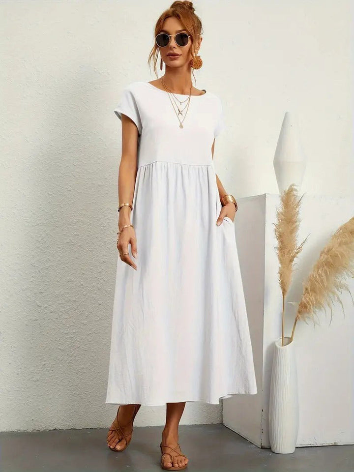 Women's fall flowing midi dress with pockets, offering style and comfort.