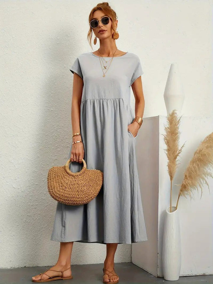 Chic women's Madison midi dress, flowing and comfortable, with functional pockets.