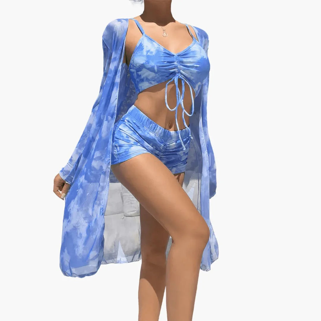 Women's vacation outfit: Colorful swirl print high-waisted shorts, crop top, and kimono cover up.