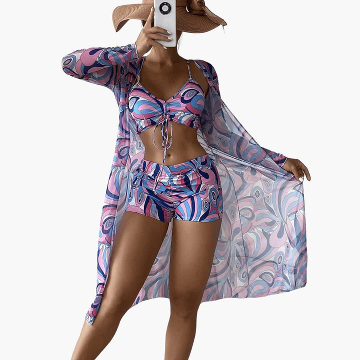 Flowy women's kimono, crop top & high-waisted shorts with vibrant swirl print. Perfect beachwear.