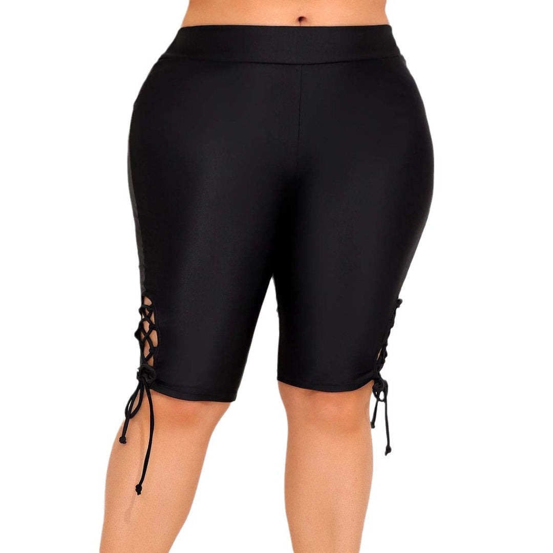 Close-up of lace-up cut-out details on stylish women's high-rise bike shorts. Trendy summer activewear fashion.
