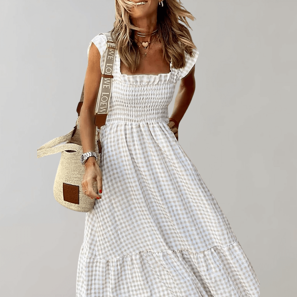 Elegant women's smocked gingham maxi dress with tiered skirt, perfect for summer fashion and day wear.