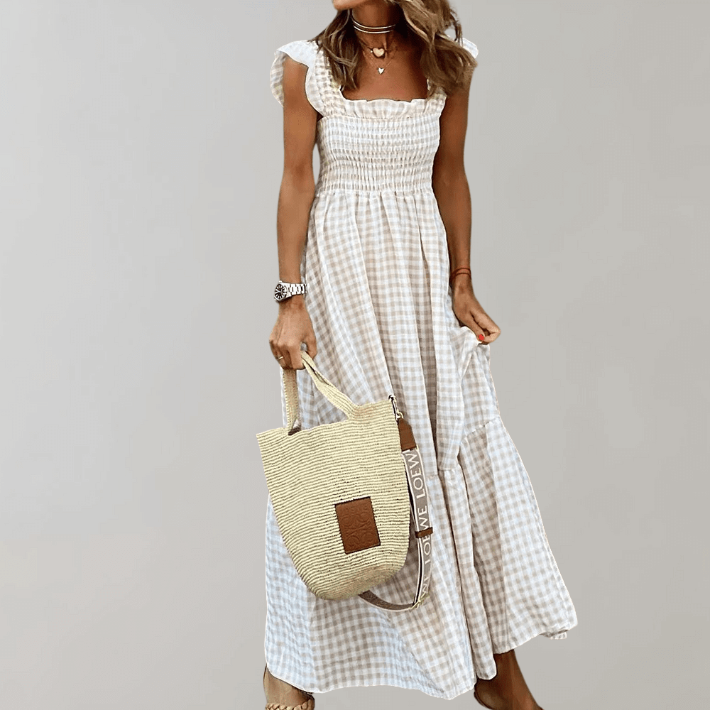 Women's gingham maxi dress with a flattering square neckline and smocked bodice, ideal for casual summer days.