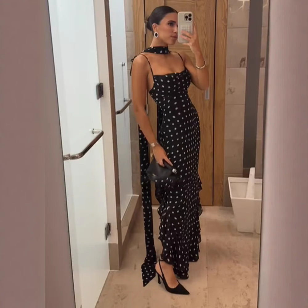 Chic women's races dress, a black polka dot tiered maxi for elegant garden parties.