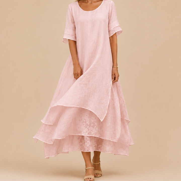 Women's pink flowy tiered ruffle maxi dress with scoop neck, perfect for summer vacation style.