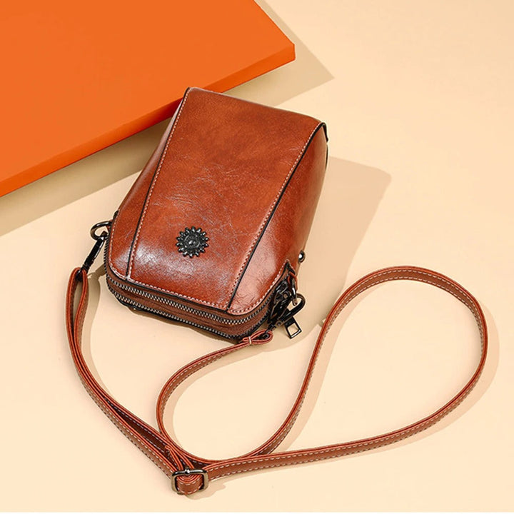 Women's stylish black leather handbag, a versatile shoulder bag with adjustable strap for daily use.