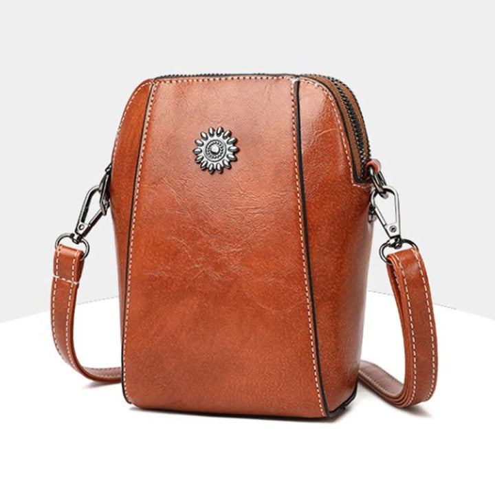Brown leather women's stylish shoulder bag, an adjustable everyday handbag accessory.