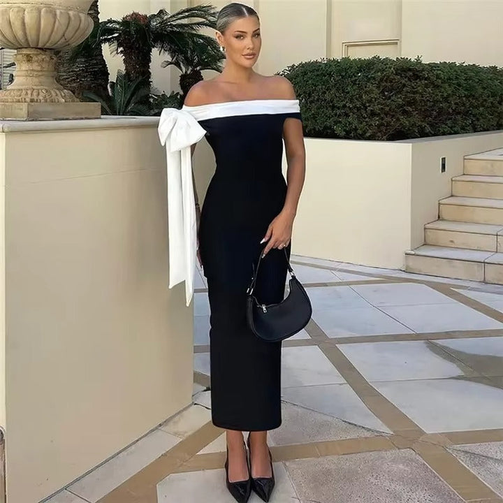 Fashionable women's black off-shoulder midi dress for special occasions. An elegant choice for evening wear.