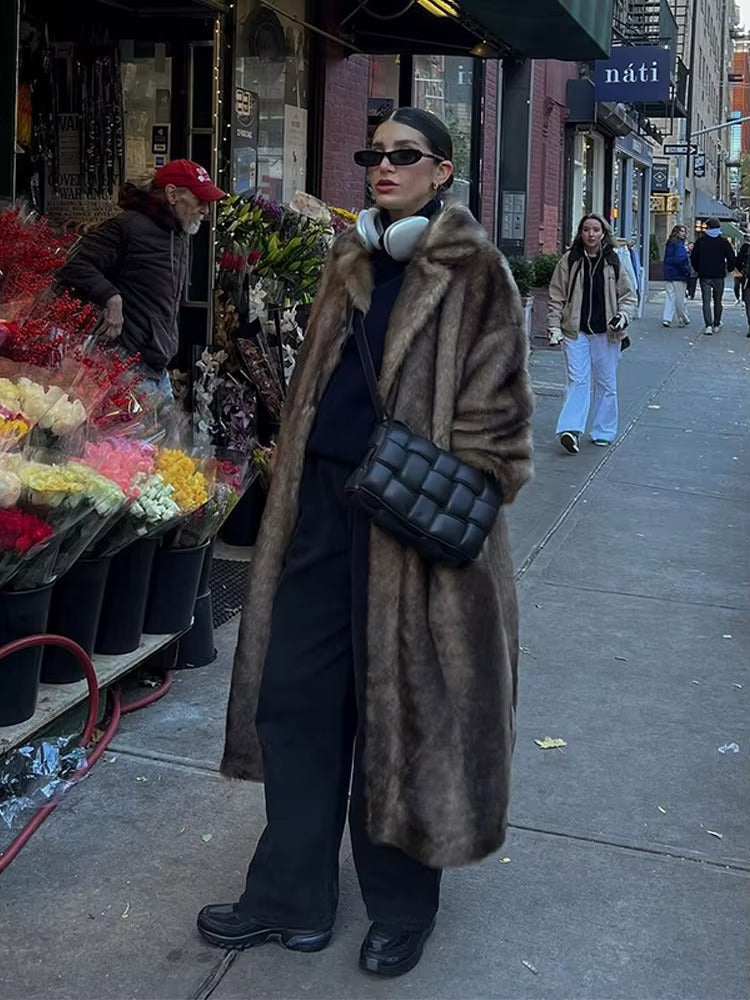 Luxurious dark brown women's long winter coat, elegant and warm, ideal outerwear for chilly winter fashion.