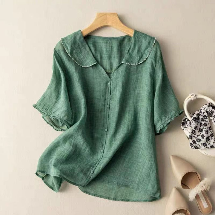Women's graceful blouse with scalloped collar, button-up front, and half sleeves. Elegant vintage style for office or casual.