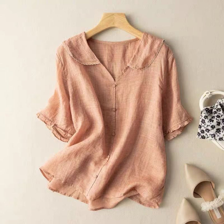 Relaxed fit women's summer blouse, featuring a chic scalloped collar and button-up design. Feminine spring fashion.