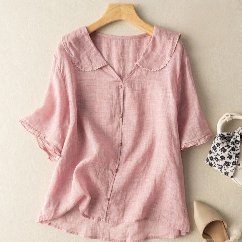 Feminine women's blouse with a distinctive scalloped collar and button-up detail. Perfect for a vintage-inspired look.