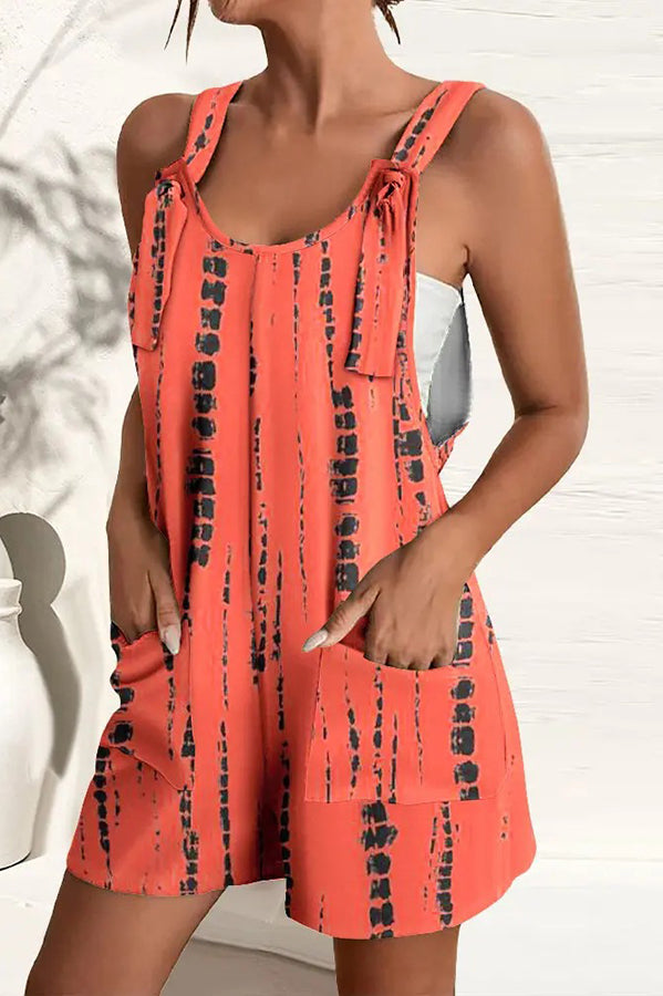 Women's vibrant print wide-leg summer jumpsuit with adjustable straps & pockets, perfect for casual or vacation wear.