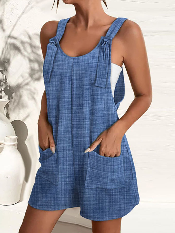 Chic women's casual summer jumpsuit with wide legs, adjustable straps, vibrant print, and functional pockets.
