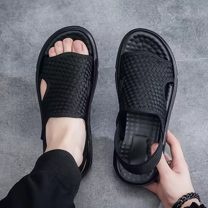 Men's black woven orthopedic sandals with adjustable strap, offering arch support & cushioned sole for comfort.