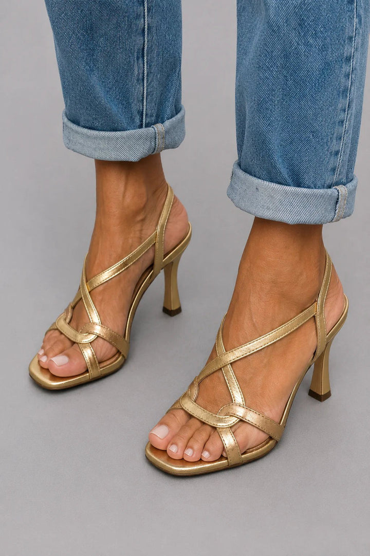 Elegant women's metallic beige cross-strap heeled sandals with square toe, perfect for evening parties.