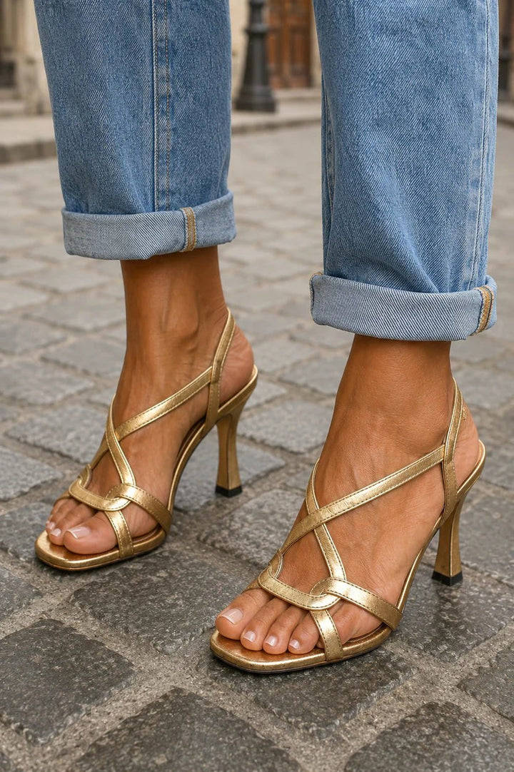Shimmering beige metallic cross-strap heeled sandals for women, ideal formal shoes for evening events.