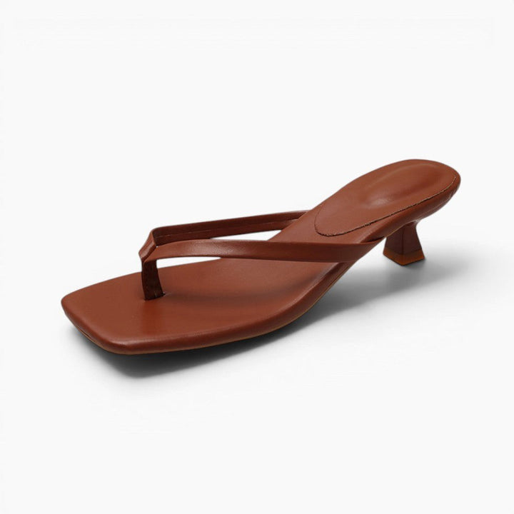 Elegant women's thong sandals with sturdy block heel. Minimalist design offers comfort for casual or evening wear.