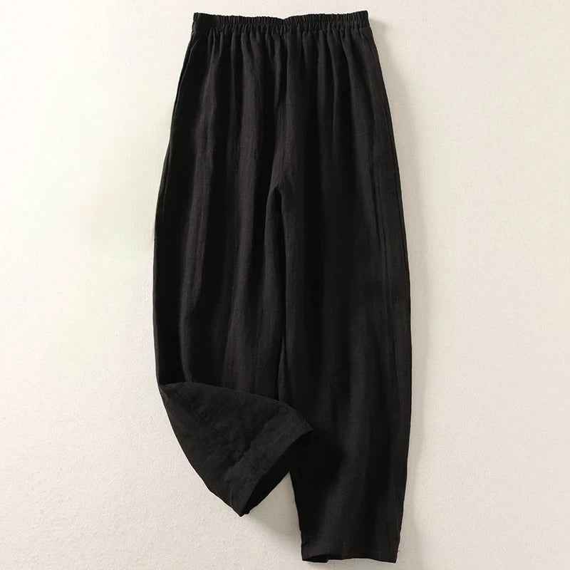 Women's relaxed wide leg linen pants with elastic waist shown on model. Offers comfortable, flowy, versatile summer style.