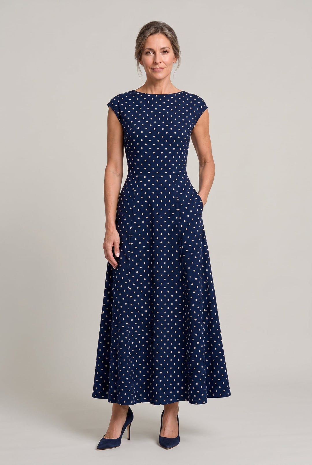 Classic women's polka dot printed maxi dress with subtle cap sleeves, ideal for elegant formal wear.