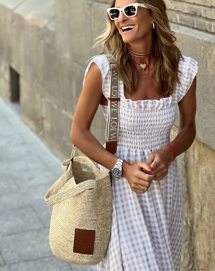 White gingham smocked maxi dress with flutter sleeves, a beautiful and comfortable summer vacation outfit.