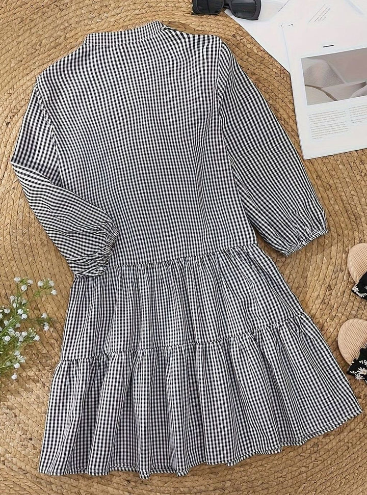 Casual women's mini dress: black & white gingham pattern, tiered design, fashionable puff sleeves.