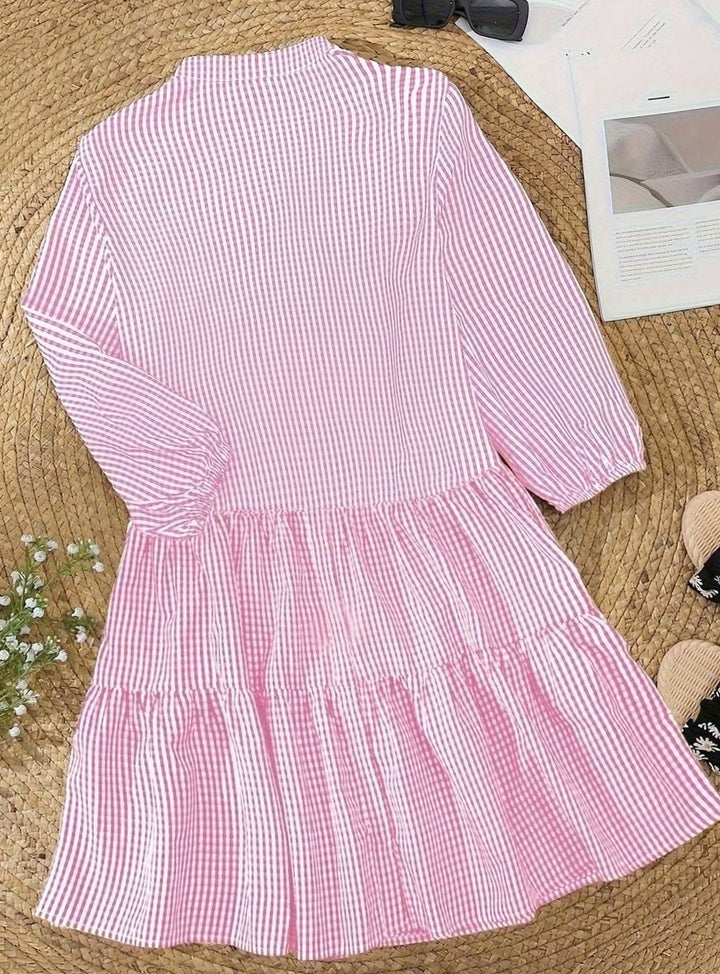 Front view of women's gingham mini dress, showing tiered skirt, puff sleeves, and chic casual design.