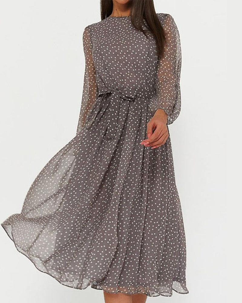 Women's cosy polka dot A-line midi dress with long sleeves and tie waist, perfect for smart casual or office wear.