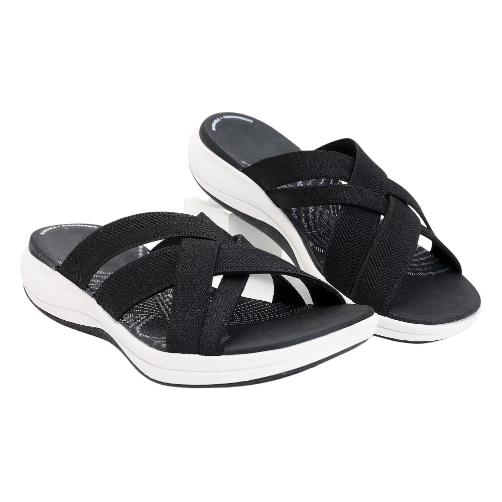 Stylish women's slip-on sandals with cushioned cross-straps, perfect for summer comfort.