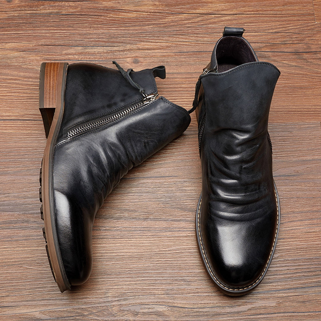 Man wearing black men's ankle zip work boots for everyday use.