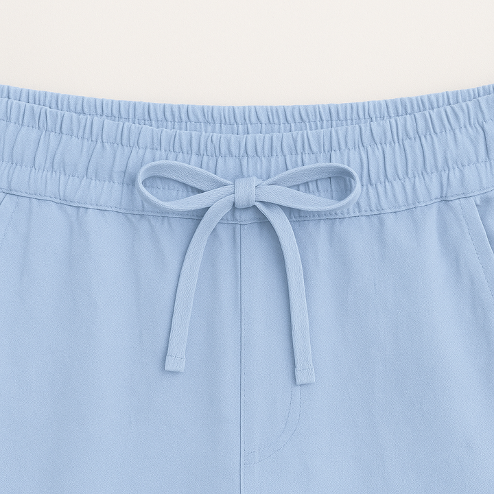 Men's versatile casual outfit: button-up shirt & drawstring shorts. Ideal for summer style and comfort.