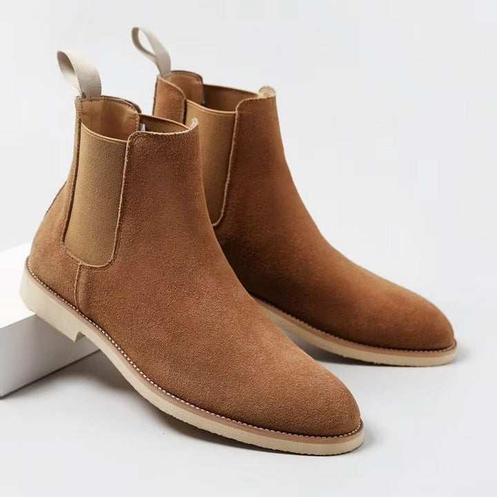 Side profile of men's fashionable ankle boots, showcasing the elastic gore for a snug fit.