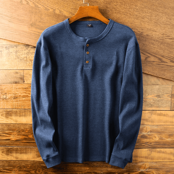 Close-up of the henley neckline on a men's classic t-shirt, highlighting ribbed cuffs.