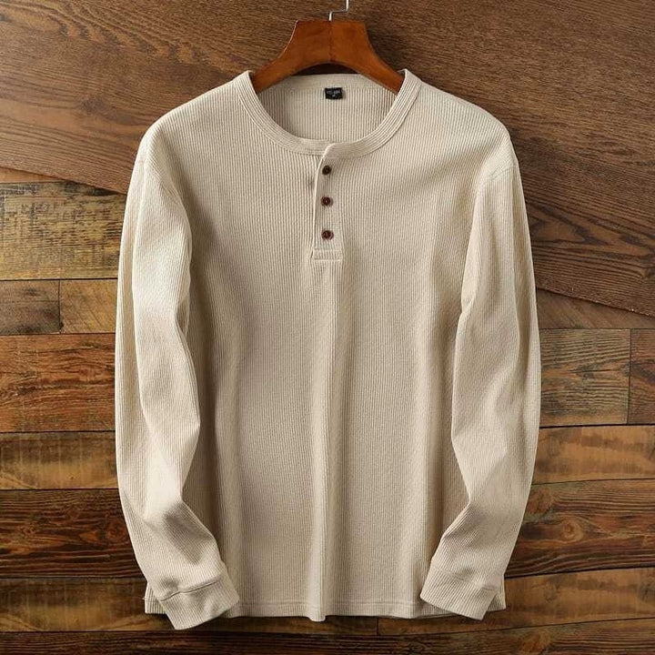 Man wearing a men's casual long sleeve henley shirt, demonstrating its comfortable fit.