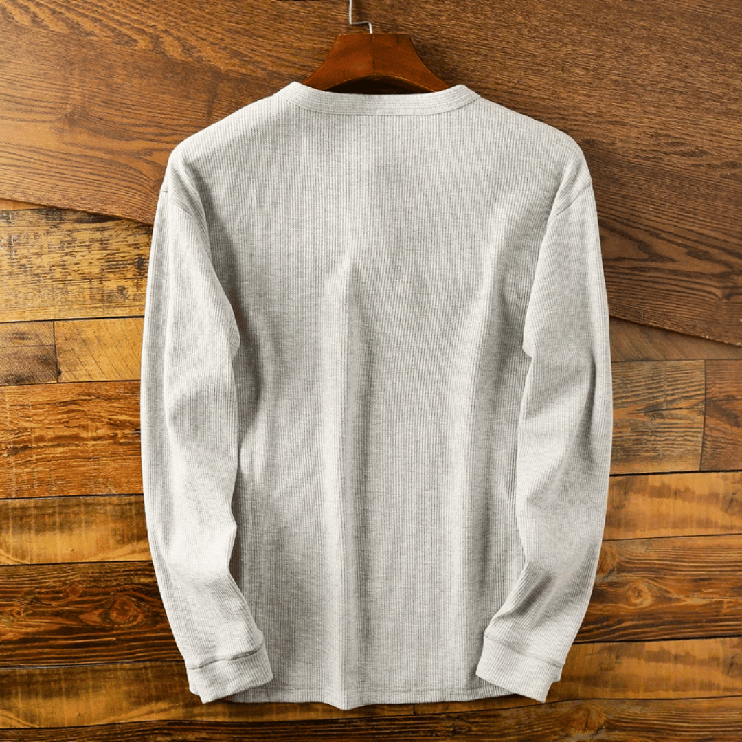 Detail shot of the three-button placket on a men's classic style henley shirt.