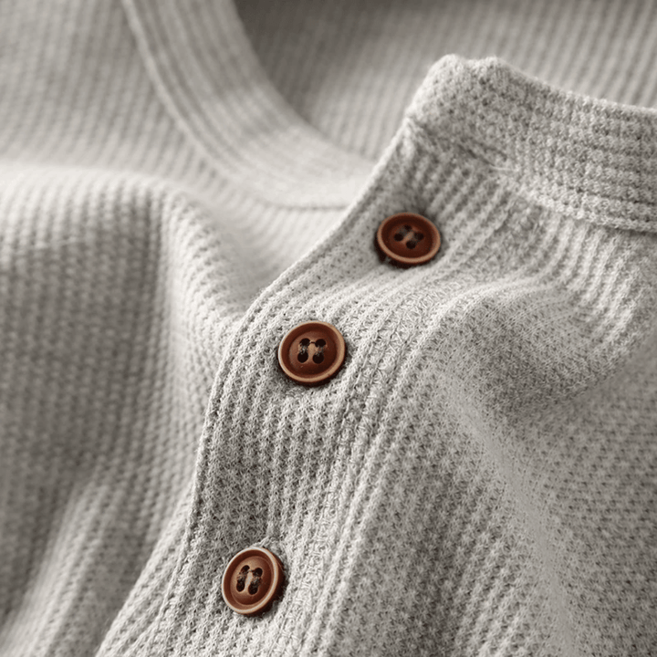 Outfit idea: Men's henley neck t-shirt paired with jeans for a relaxed, classic look.