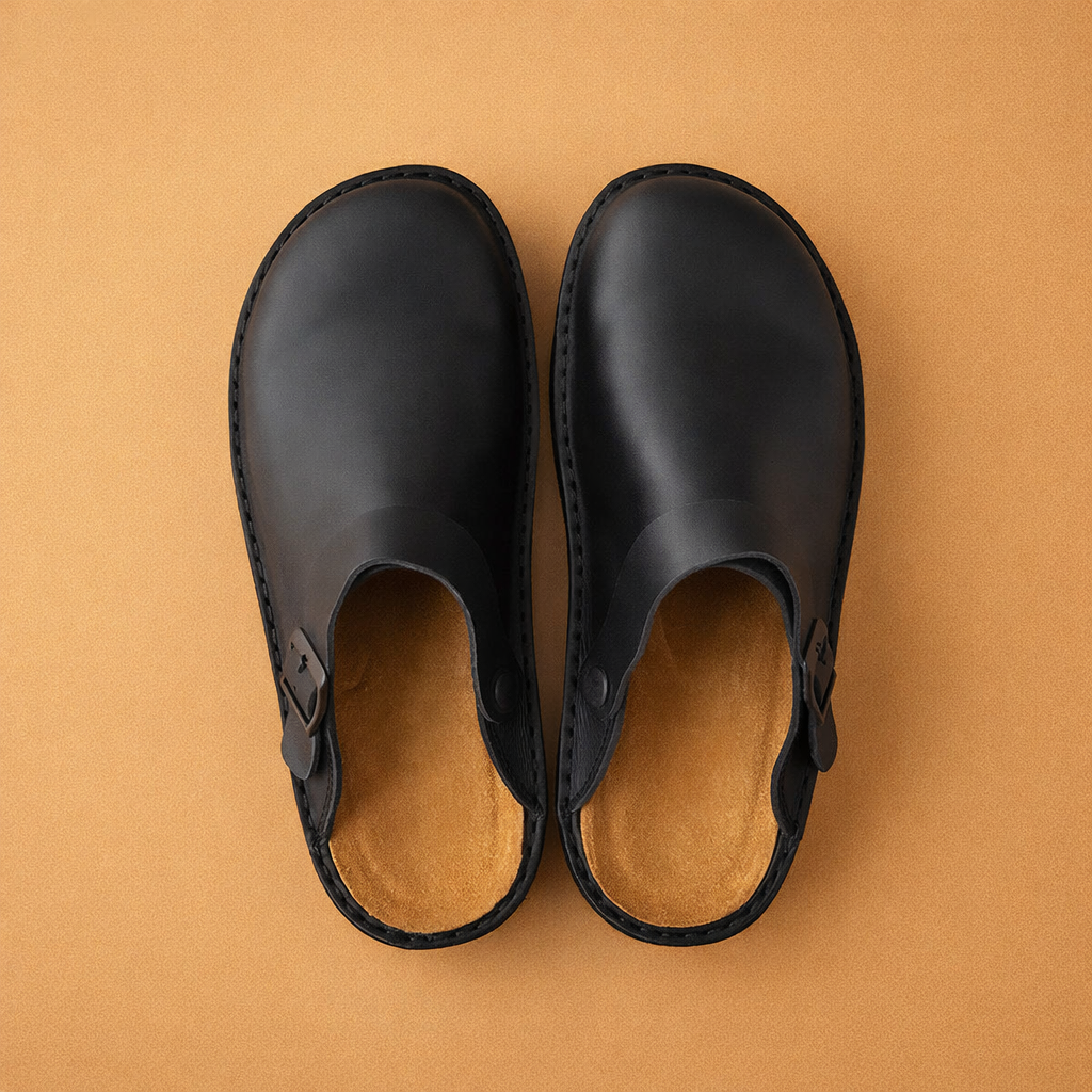 Close-up of men's slip-on clogs showing the comfortable interior and adjustable strap.