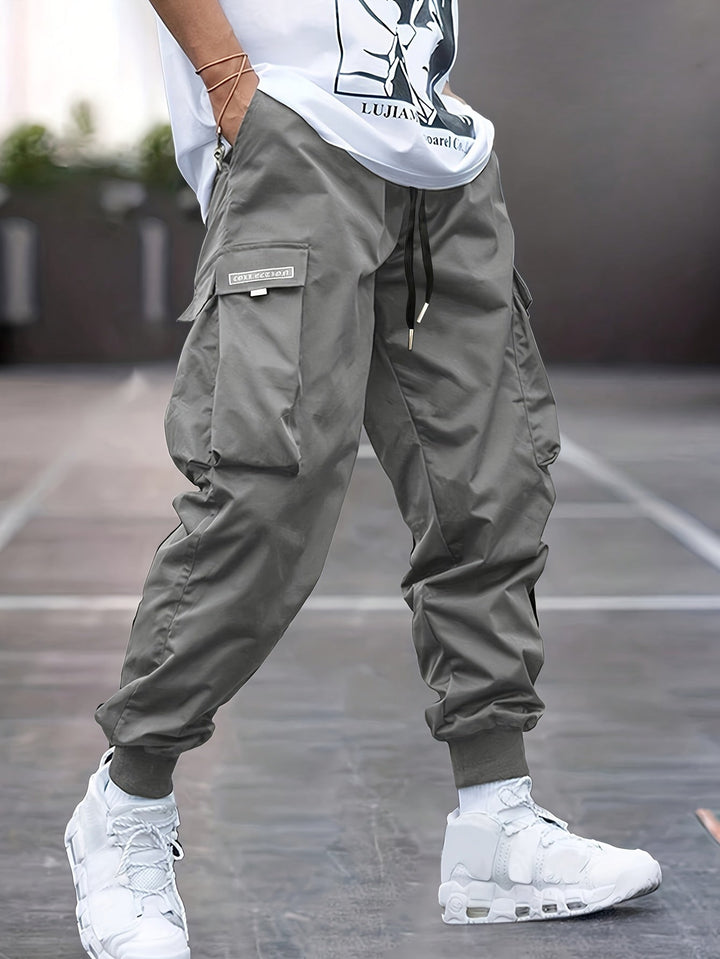 Comfortable men's drawstring cargo pants, relaxed fit, multi-pocket utility design for versatile outdoor wear.