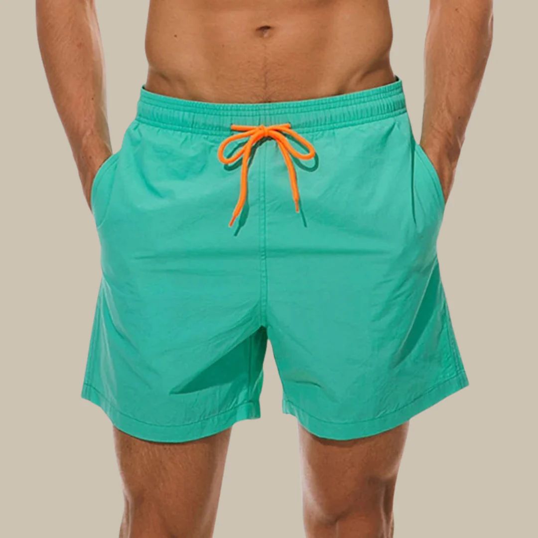 Stylish men's swim trunks with side pockets, ideal for summer beach days.