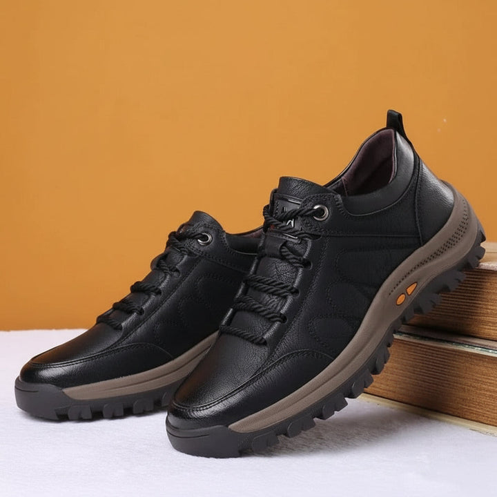 Close-up of men's waterproof walking shoes showing durable sole and arch support.