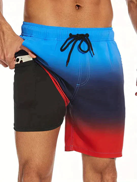 Model wearing men's printed drawstring swim shorts for a resort look