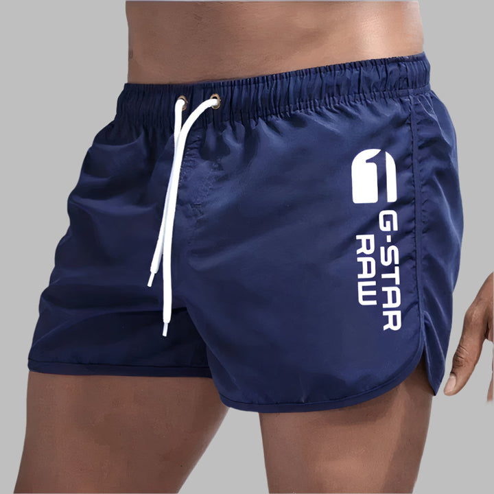 Comfortable men's beachwear featuring quick dry swim trunks.