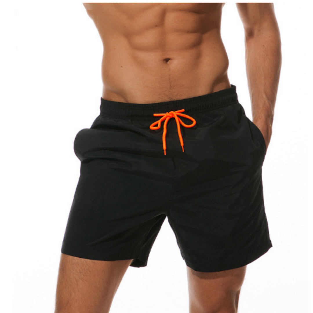 Men's quick-drying swim shorts, ideal for summer comfort & beach days.