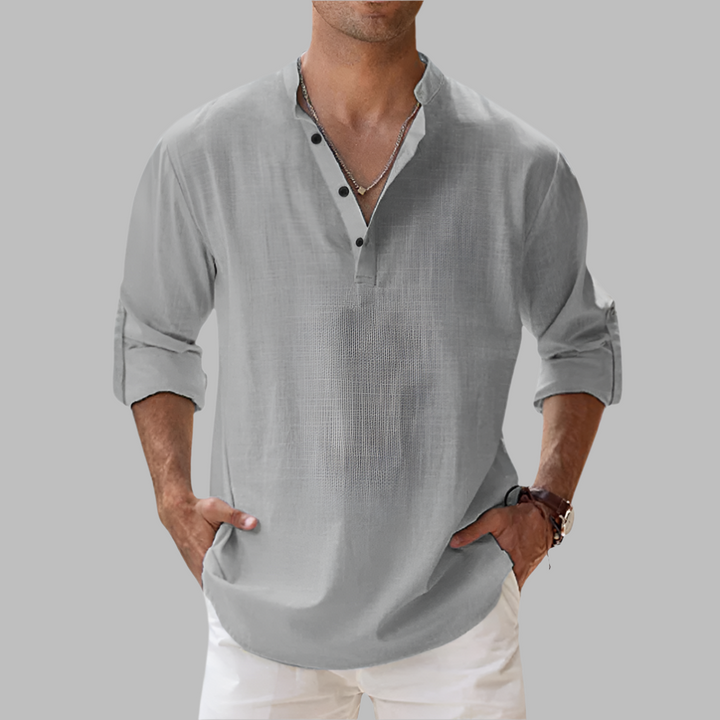 Model wearing a casual linen button-down shirt for summer vacation.