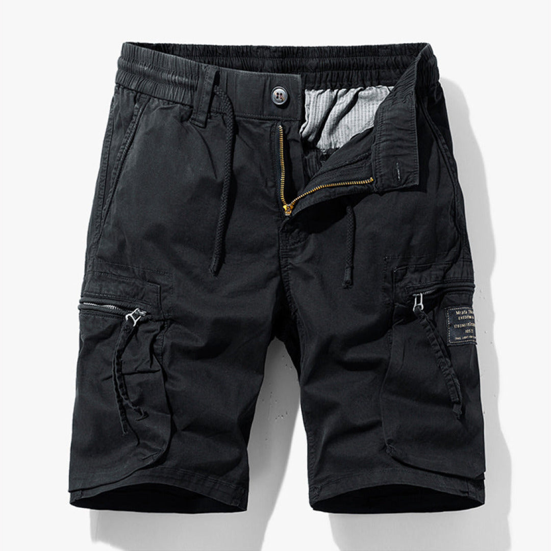 Army green men's relaxed fit cargo shorts, perfect for outdoor adventures. Knee-length utility shorts with multiple pockets.