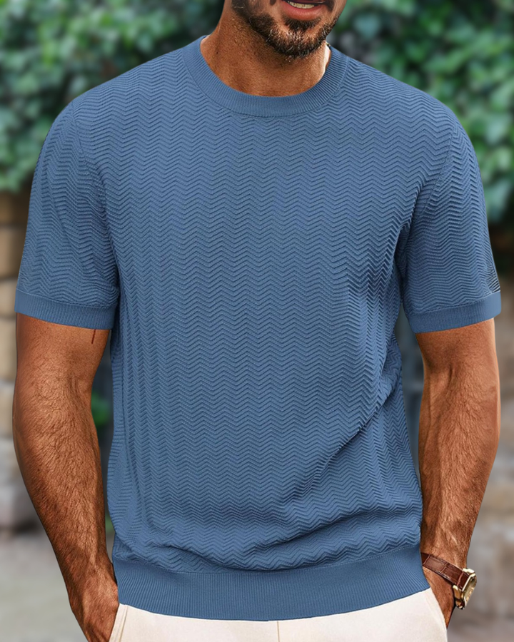 Close-up of the textured knit fabric on a men's basic round neck tee.
