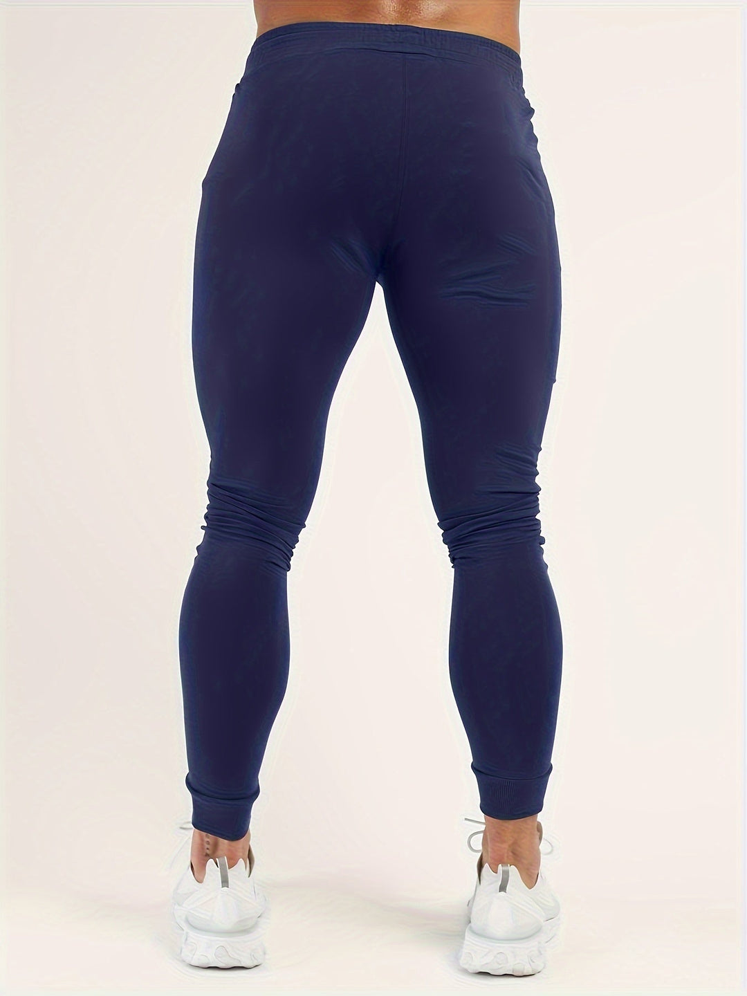 Side view of men's slim fit polyester joggers, showcasing the tapered leg.