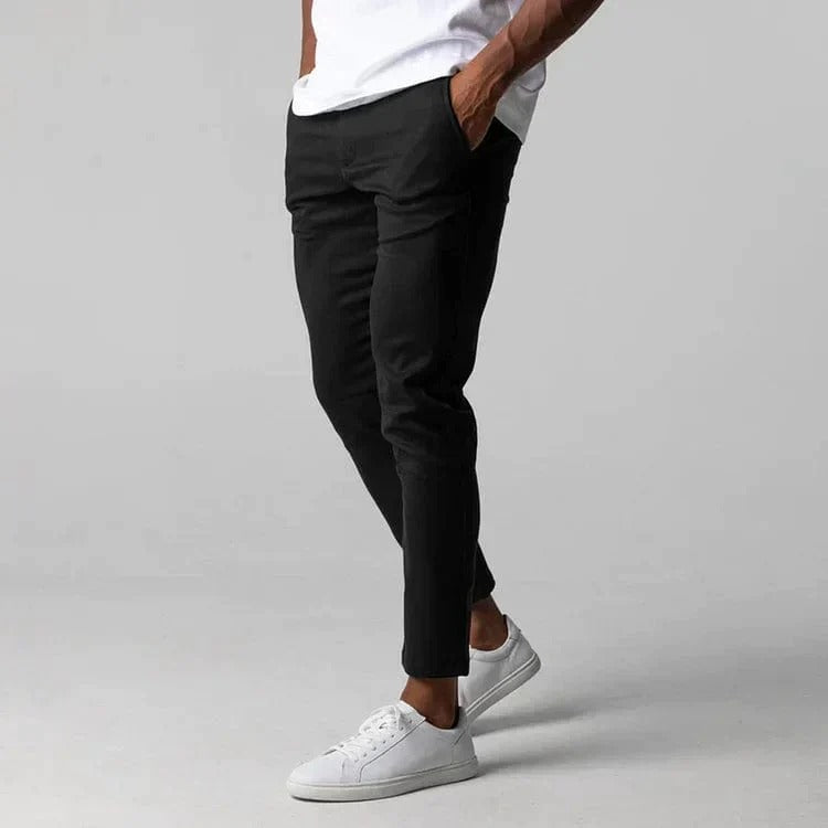 Model wearing comfortable men's stretch chinos, showcasing the slim fit design.